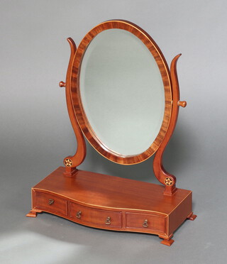 A Georgian style oval plate dressing table mirror contained in a mahogany swing frame, on a base of serpentine outline fitted 3 drawers, raised on ogee bracket feet 59cm h x 43cm w x 21cm d 