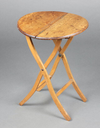 A 19th Century circular mahogany folding coaching table, the top with cribbage board 52cm h x 39cm diam. 
