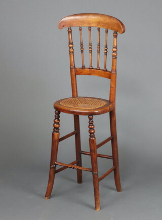 A 19th Century mahogany stick and bar back training chair with woven cane seat on turned supports 94cm h x 28cm w x 25cm d   