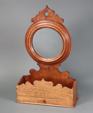 A 19th Century circular plate wall mirror, contained in a mahogany frame, the base incorporating a niche and drawer 50cm h x 31cm w x 12cm d 