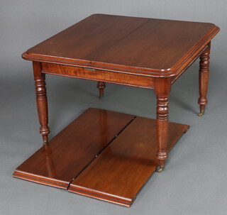 A 19th Century mahogany extending dining table with 2 extra leaves raised on turned supports ending in brass caps and casters, 74cm h x 109cm w x 104cm l x 148cm l when extended 