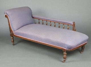 A Victorian carved mahogany chaise longue with bobbin turned decoration upholstered in blue material, raised on turned supports 174cm h x 166cm w x 60cm d (seat 110cm w x 47cm d)   