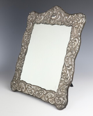 A Victorian style repousse silver easel mirror with scroll decoration and vacant cartouche, London 1987, 38cm 