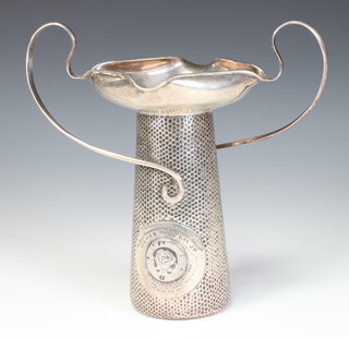 A stylish Art Nouveau hammer pattern silver plated two handled trophy with presentation inscription, 21cm