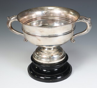 A silver 2 handled trophy cup with waisted stem, Sheffield 1922 by Walker and Hall, 688 grams, 28cm, with wooden socle 