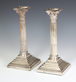 A pair of Victorian silver Corinthian column candlesticks on stepped bases Sheffield 1898, 24cm 