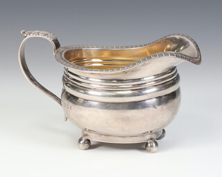 A Georgian style silver cream jug with S scroll handle on ball feet London 1923, 197 grams, by The Goldsmiths and Silversmiths Company 