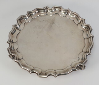 A Georgian style silver card tray with Chippendale rim on scroll feet 19cm, London 1917, 328 grams 