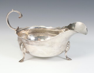 A Victorian silver sauce boat with wavy rim, S scroll handle, shell knees and hoof feet Birmingham 1897, 201 grams 