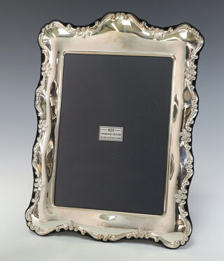 A Victorian style repousse silver rectangular photograph frame Sheffield 2011, 26cm x 19cm, boxed 