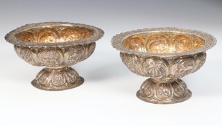 A pair of Indian white metal repousse pedestal bowls decorated with flowers and animals 11.5cm, 198 grams 