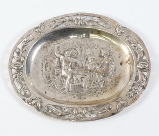 A European repousse silver dish decorated with a blacksmiths scene with pierced rim, having import marks for London 1881, 13cm, 77 grams 