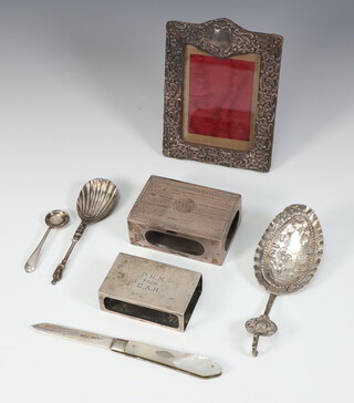 An engraved silver matchbox holder London 1911, a smaller Edwardian ditto Birmingham 1909, 3 spoons, a photo frame and a fruit knife, weighable silver 109 grams