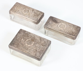 Three silver mounted toilet boxes with engraved scroll decoration and monogram, London 1877 and 1880 