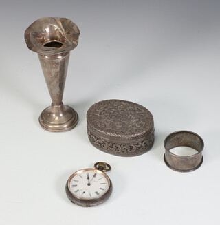 A silver spill vase Birmingham 1925, 12cm, dented, an oval white metal box, a napkin ring and a mechanical pocket watch 