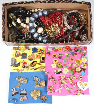 A collection of vintage costume jewellery and pin badges 