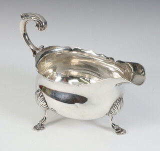 A George III silver sauce boat with S scroll handle, shell knees and hoof feet, London 1773, 119 grams 