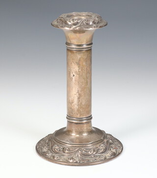 An Edwardian silver candlestick with repousse decoration Birmingham 1906 16cm 