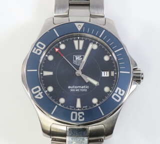 A gentleman's steel cased Tag Heuer automatic calendar wristwatch with pale blue bezel and calendar dial, inscribed Automatic 300m contained in a 43mm case WAB2011 GJ5458 on original bracelet in working condition with box, outer box and paperwork 