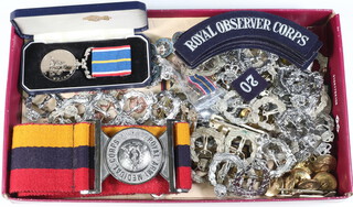 A National Service medal and miniature boxed, a Royal Army Medical Corps belt and buckle, a quantity of Royal Observer Corps cloth metal badges 