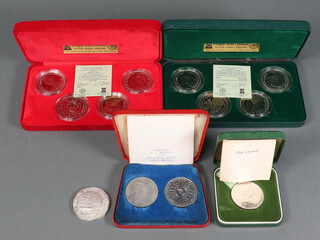 A silver commemorative crown and 4  cased sets of coins 