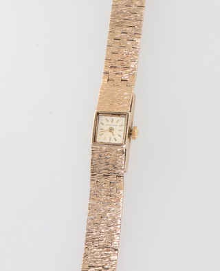 A lady's 9ct yellow gold Bueche-Girod wristwatch on a bark finished bracelet 25.2 grams including glass, contained in original case 