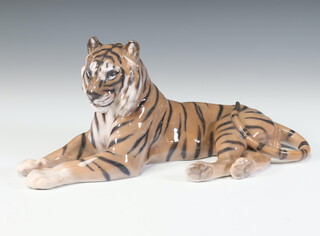 A Royal Copenhagen figure of a reclining tiger signed L Jensen 714 30cm 