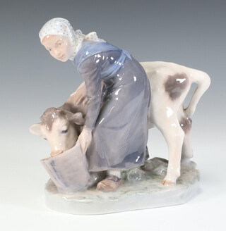 A Royal Copenhagen figure of a milkmaid and cow 779, 15cm 