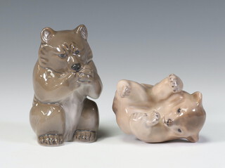 A Royal Copenhagen figure of a seated bear 3014, ditto of a seated bear 1233/1124, both 6cm together with a leaf shaped dish with frog 2477 10cm 