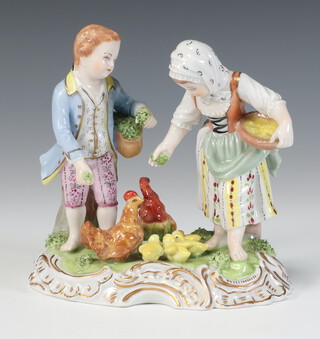 A 20th Century Dresden group of a boy and a girl feeding chickens on a rococo base 12291V 14cm 