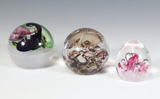 Three Caithness crystal paperweights - small owl 7cm, Tutti Frutti 2012 9cm Moonbeam 211159 7cm, and another of an owl all boxed  
