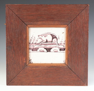 An 18th Century ochre Delft tile decorated with a pig, framed, 11cm 
