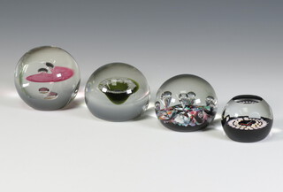 Four Caithness paperweights - Ariel no.402 of 500 7cm, Reflections no.25 of 500 7cm, miniature candle B5322 5cm and spiral canes 6cm, all boxed 