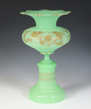 A 19th Century green glass gilt decorated flared necked vase on stand 30cm 