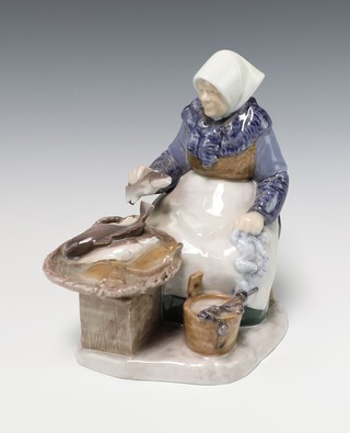 A Bing & Grondahl porcelain figure of a seated lady fishmonger, the base marked B&G 2233SA 20cm 