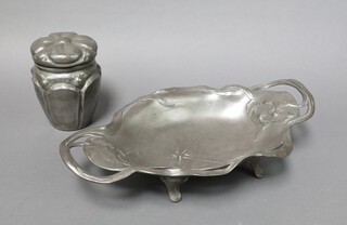 Juventa, an Art Nouveau oval twin handled pewter dish decorated a dragonfly, raised on splayed supports 7cm x 39cm x 22cm together with an A E Chamal embossed pewter caddy the top with flower decoration 14cm x 7cm 