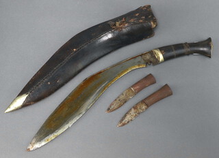 A Kukri with 30cm blade and horn grip, 2 skinning knives and leather scabbard 
