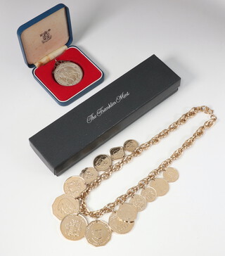 A Franklin Mint gilt coin necklace together with a 1977 silver crown 