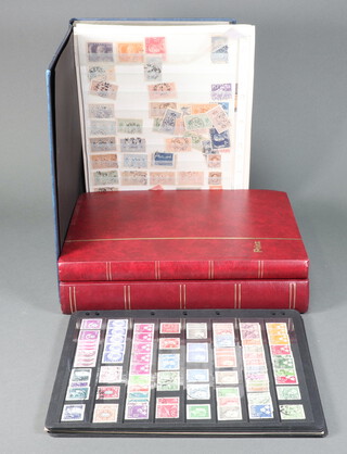 A quantity of mint and used Swedish stamps on album sheets together with 2 red empty stock books 