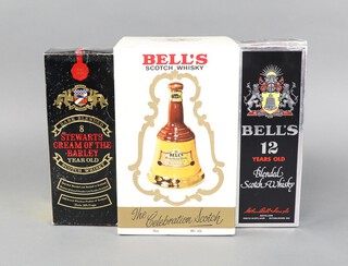 A Wade bell shaped pottery decanter containing approx. 75cl of Bells Whisky, boxed, a 70cl bottle of Bells Deluxe blended scotch whisky 40 percent proof  boxed and a 26 fluid ounce bottle of Stewarts 8 year old Cream of The Barley scotch whisky boxed  