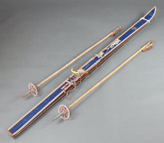 A pair of vintage Kneissl skis together with bamboo poles 