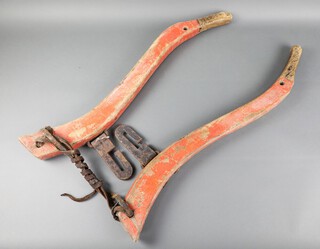 A pair of 19th Century wooden and iron horse hanes marked W.AC 