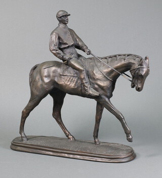 A bronzed figure of a race horse with jockey up, on an oval base 37cm h 