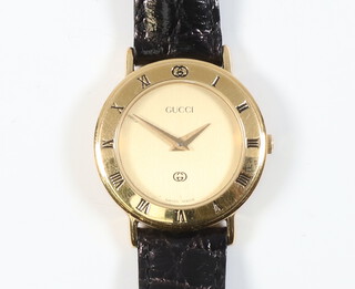 A lady's gilt cased Gucci wristwatch on a leather strap with box 