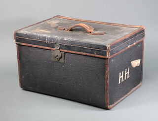 A Victorian black fibre and leather bound travelling trunk, the interior fitted a tray with hinged lid 28cm h x 46cm w x 32cm d, having various labels 