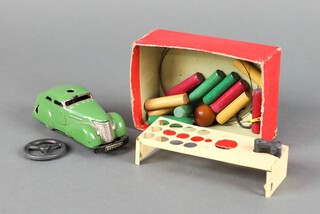 A Schuco Examico 4001 tinplate clockwork car together with a Schuco 3000 Telesteering car together with wooden bollards, steering wheel accessory  