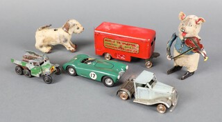 Two Schuco wind up animals of a pig playing a violin and a dog, together with a Minic Transport Road, Rail, Air and Sea Express Service truck and trailer and electric racing car  