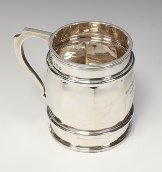 A silver octagonal barrel shaped mug with C scroll handle Birmingham 1929, 8.5cm, 186 grams 