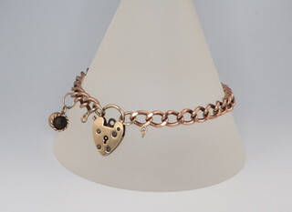 A yellow metal 9ct bracelet with charm and heart padlock 15.4 grams 