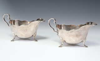 A pair of Edwardian silver sauce boats with S scroll handles and hoof feet Sheffield 1910, 14cm, 249 grams 